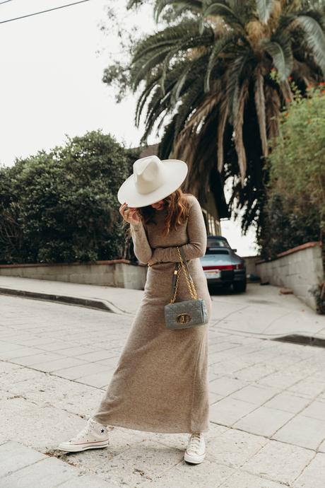 Sara from Collage Vintage wearing a midi knit dress, all star sneakers and cloud blue Caro Dior bag