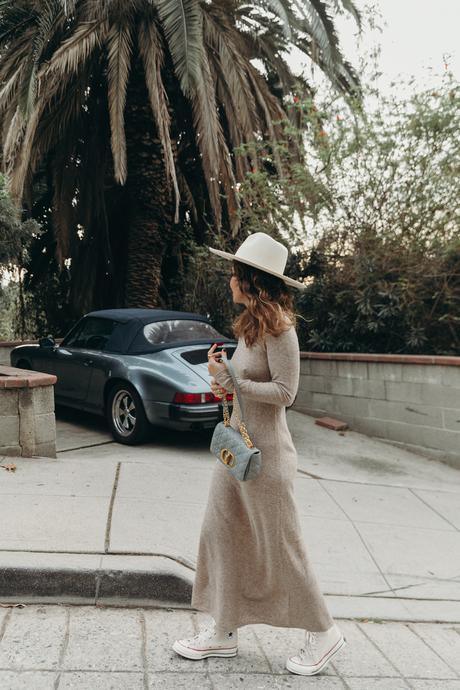 Sara from Collage Vintage wearing a midi knit dress, all star sneakers and cloud blue Caro Dior bag