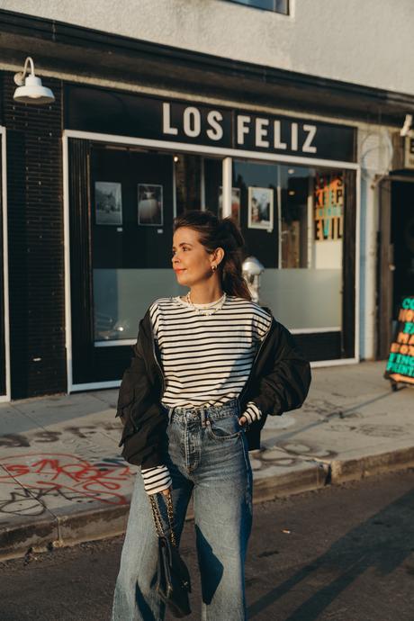 Sara from Collage Vintage wearing a bomber jacket and a striped tee shirt