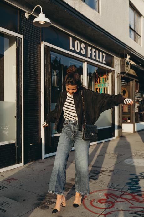 Sara from Collage Vintage wearing a bomber jacket and a striped tee shirt