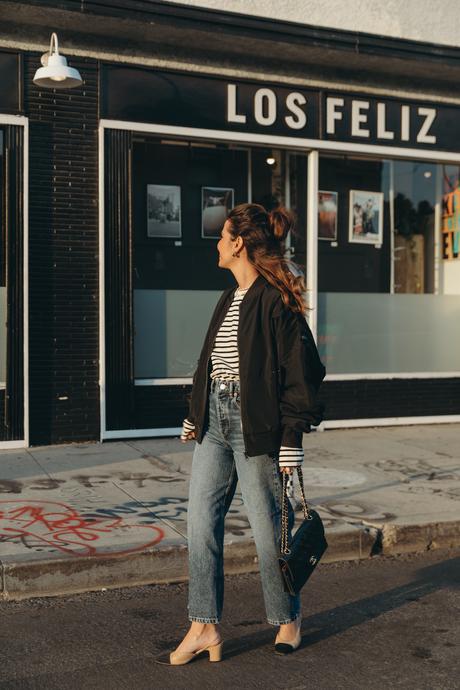 Sara from Collage Vintage wearing a bomber jacket and a striped tee shirt