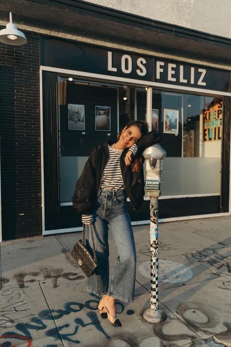 Sara from Collage Vintage wearing a bomber jacket and a striped tee shirt