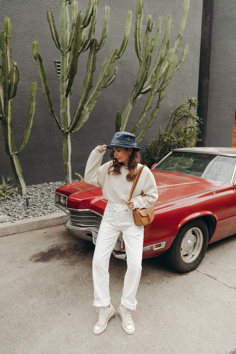 Sara from Collage Vintage wearing Agolde white jeans, Dior denim bucket hat and Converse All-Star