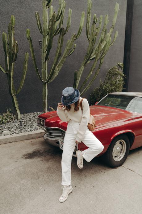 Sara from Collage Vintage wearing Agolde white jeans, Dior denim bucket hat and Converse All-Star