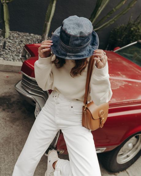 Sara from Collage Vintage wearing Agolde white jeans, Dior denim bucket hat and Converse All-Star