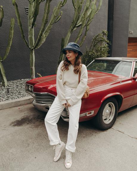 Sara from Collage Vintage wearing Agolde white jeans, Dior denim bucket hat and Converse All-Star