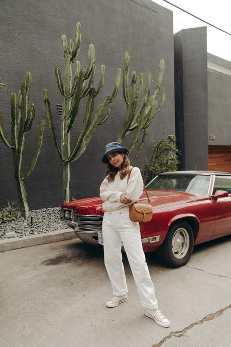 Sara from Collage Vintage wearing Agolde white jeans, Dior denim bucket hat and Converse All-Star