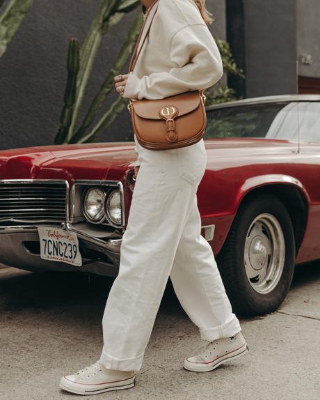 Sara from Collage Vintage wearing Agolde white jeans, Dior denim bucket hat and Converse All-Star