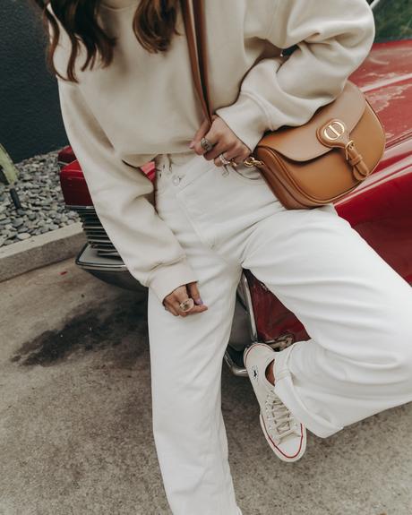 Sara from Collage Vintage wearing Agolde white jeans, Dior denim bucket hat and Converse All-Star