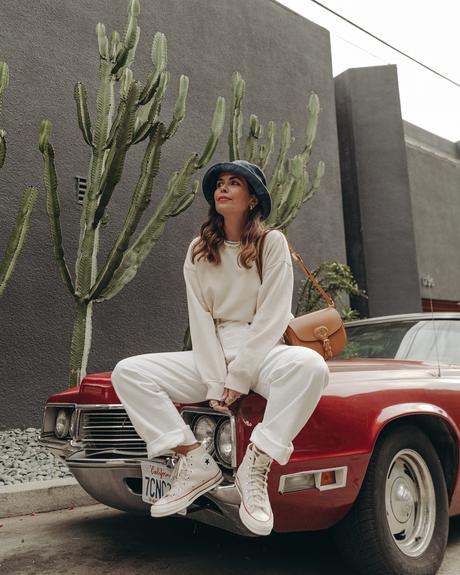 Sara from Collage Vintage wearing Agolde white jeans, Dior denim bucket hat and Converse All-Star