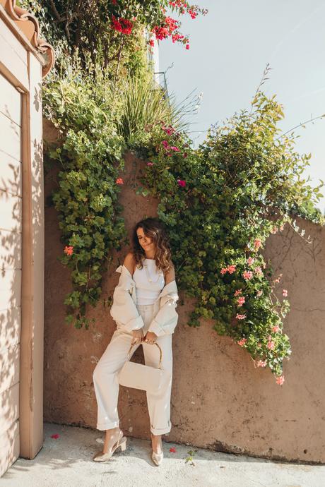 Sara from Collage Vintage wearing Mother jeans, cream raffia Cult Gaia bag and Agolde denim jacket