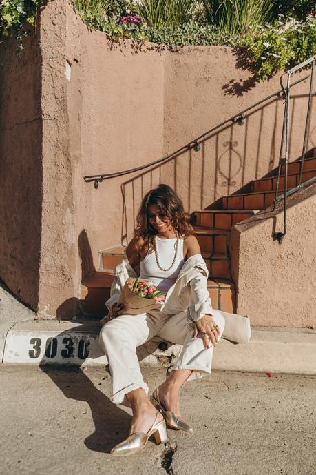 Sara from Collage Vintage wearing Mother jeans, cream raffia Cult Gaia bag and Agolde denim jacket