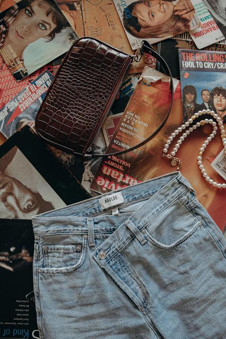 Must-loved denim wearing Agolde jeans and cropped sweatshirt at home