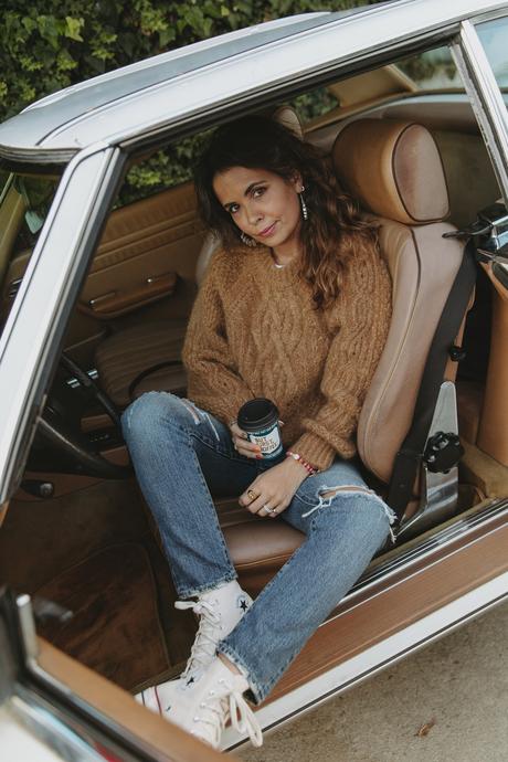 Morning coffee Sara is wearing Isabel Marant camel knit sweater, Moussy Vintage tapered jeans, By Far leather bag and All-Star retro sneakers