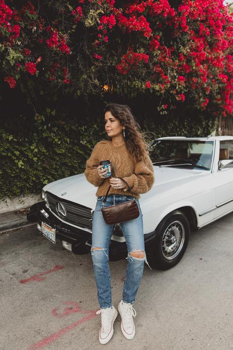 Morning coffee Sara is wearing Isabel Marant camel knit sweater, Moussy Vintage tapered jeans, By Far leather bag and All-Star retro sneakers