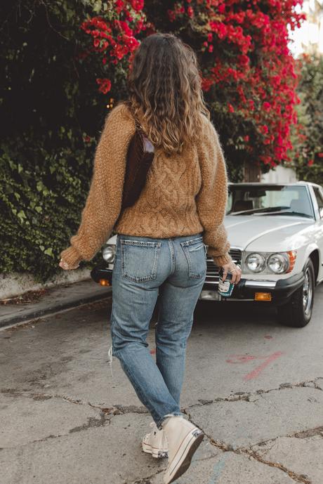 Morning coffee Sara is wearing Isabel Marant camel knit sweater, Moussy Vintage tapered jeans, By Far leather bag and All-Star retro sneakers