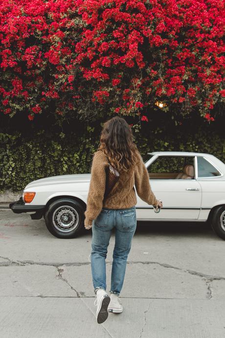 Morning coffee Sara is wearing Isabel Marant camel knit sweater, Moussy Vintage tapered jeans, By Far leather bag and All-Star retro sneakers