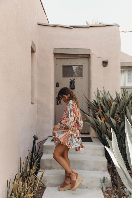 Sara from Collage Vintage is wearing a Zimmermann mini dress, See by Chloé wedged sandals and Loewe crossbody bag
