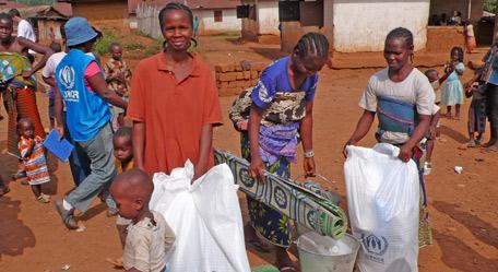 Una viuda de Côte d'Ivoire responsable de una familia de cinco recibe un paquete de ayuda del ACNUR en Liberia para su familia.