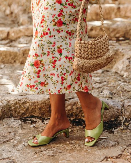 Sara from Collage Vintage wearing a summer midi floral dress, green mules and a mini basket
