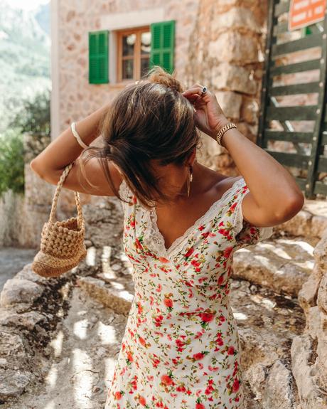 Sara from Collage Vintage wearing a summer midi floral dress, green mules and a mini basket