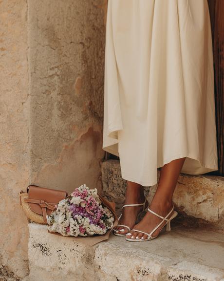 Sara from Collage Vintage is wearing a Cettire total look, Khaite Ren Ruched Midi Dress, Reike Nen Sandals, Loewe Gate Bag