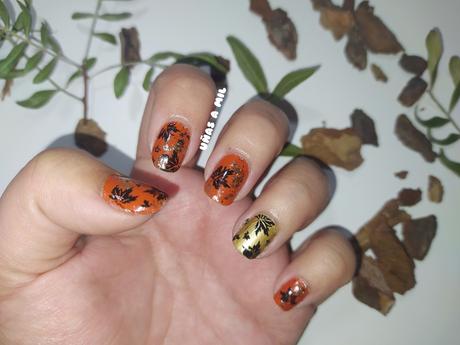 Diseño de uñas en naranja y dorado con hojas, ideal para Otoño