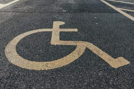 painted disability icon on pavement