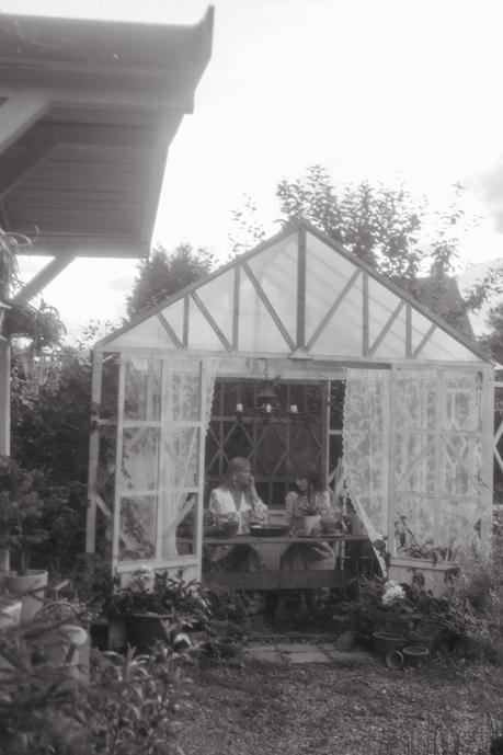 grayscale photography of people in a greenhouse