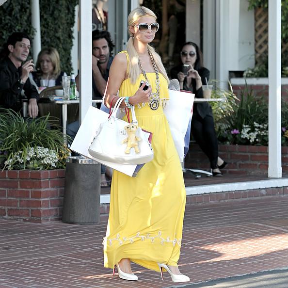 Paris Hilton Paris Hilton wears a spring yellow dress and clutches an armful of shopping bags as she leaves trendy shopping boutique Fred Segal in Hollywood.