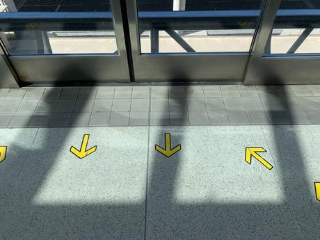 yellow arrows on tiled floor in building
