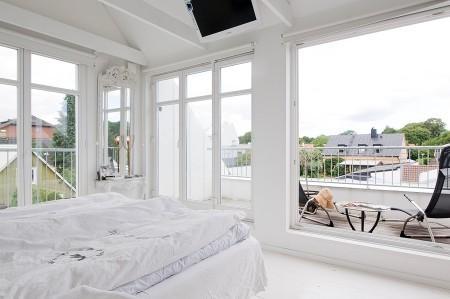 villa en suecia tragaluz en el comedor sofá en el baño piel de cordero en decoración muebles de terraza muebles de ikea muebles blancos grandes ventanales estilo nórdico estilo escandinavo diseño nórdico diseño de terrazas diseño de interiores decoración sueca decoración en blanco decoración de interiores cocinas con isla cocinas con armarios altos cocina moderna cocina blanca claraboya en una casa baño con piedra caliza 