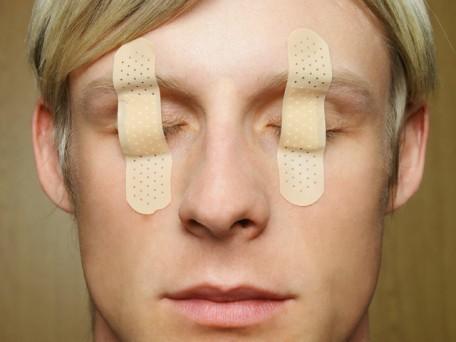 Man with bandages over eyes