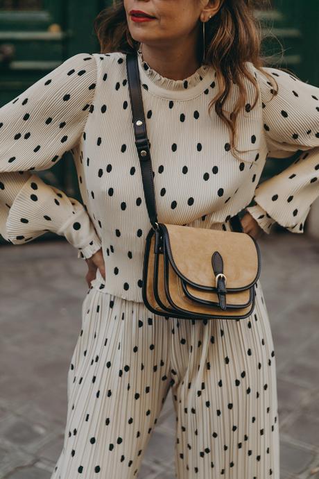 Sara from Collage Vintage at Saint Germain Paris wearing a Sézane polka dots set and a leather crossbody bag.