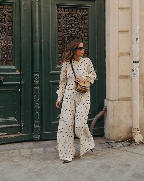 Sara from Collage Vintage at Saint Germain Paris wearing a Sézane polka dots set and a leather crossbody bag.