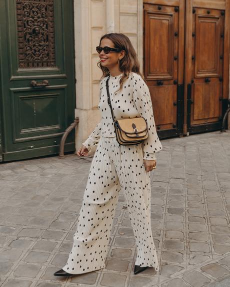 Polka dots set Sara from Collage Vintage at Saint Germain Paris wearing a Sézane polka dots set and a leather crossbody bag.