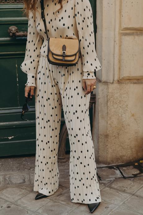 Sara from Collage Vintage at Saint Germain Paris wearing a Sézane polka dots set and a leather crossbody bag.