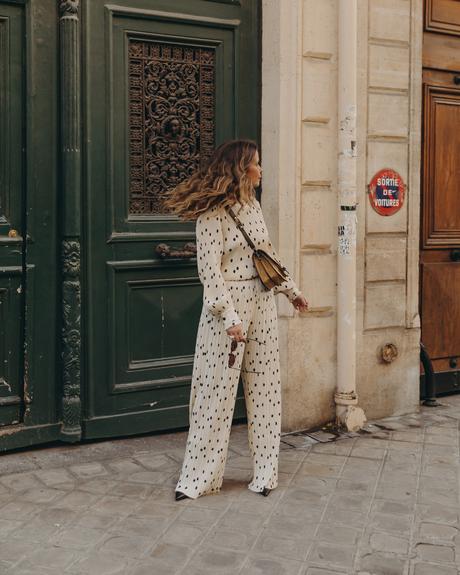 Sara from Collage Vintage at Saint Germain Paris wearing a Sézane polka dots set and a leather crossbody bag.