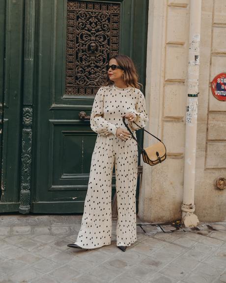 Sara from Collage Vintage at Saint Germain Paris wearing a Sézane polka dots set and a leather crossbody bag.