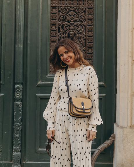 Sara from Collage Vintage at Saint Germain Paris wearing a Sézane polka dots set and a leather crossbody bag.