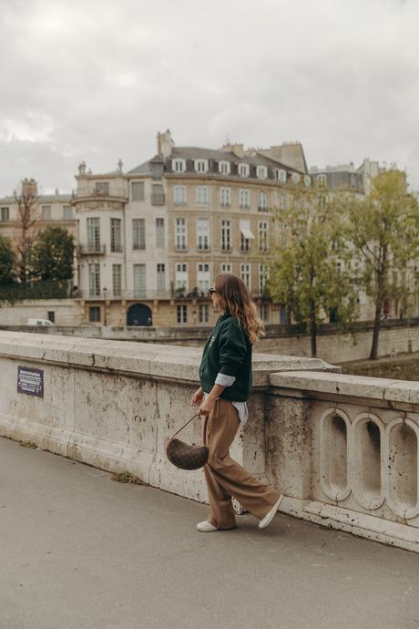 Sara from Collage Vintage at Paris Fashion Week wearing a oversize green sweatshirt, camel trousers, Louis Vuitton vintage bag and sneakers.