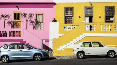 cars parked near colorful houses
