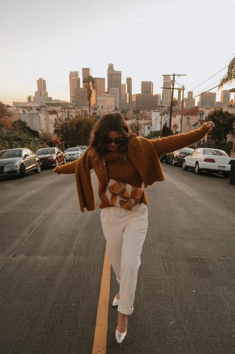 Collage Vintage wearing a Sézane outfit. Knit gold jumper, white pants, patchwork bag and Chanel shoes