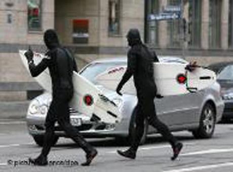 Surfers crossing a busy street