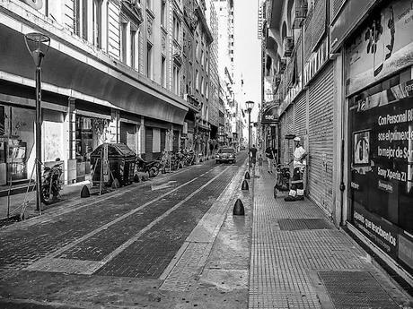 Un obrero Municipal en la vereda descansa en una calle solitaria