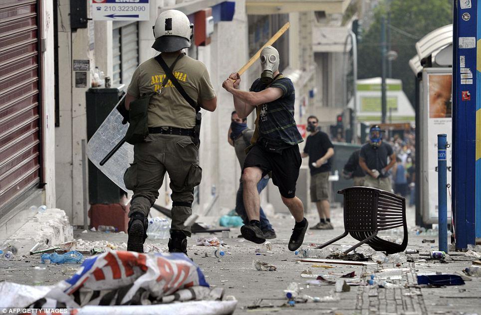 ON THE ATTACK: Protesters clash with riot police during a 48-hour general strike on June 28 in Athens