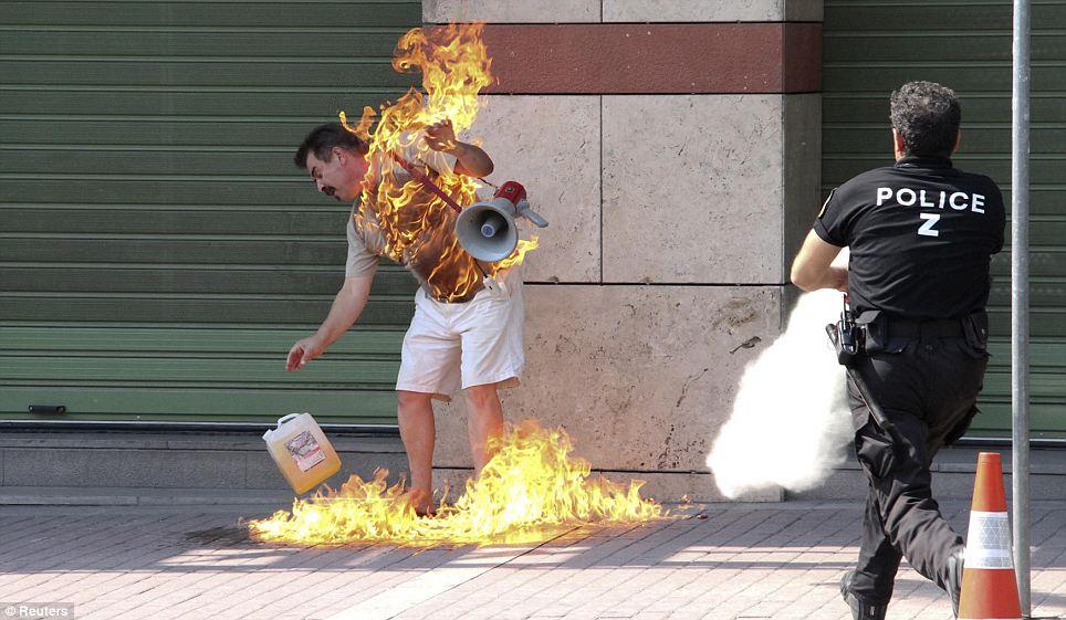 DESPERATE: A man sets himself on fire outside a bank branch in Thessaloniki, Greece, on September 16. The bank had refused to renegotiate the 55-year old's overdue loan payment 