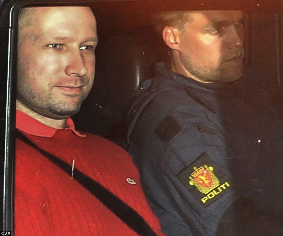 FACE OF EVIL: Mass-killer Anders Breivik, left, sits in an armored police vehicle after leaving an Oslo courthouse on July 25