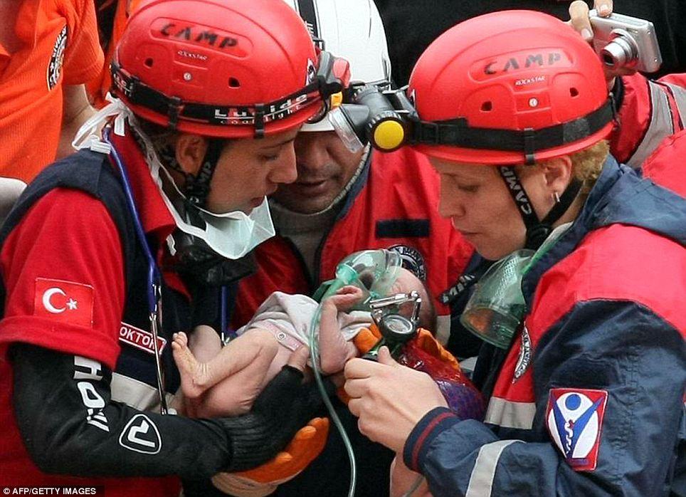 SAVED: Rescuers carry two-week-old baby girl Azra Karaduman from the rubble of a collapsed building in Ercis, in Turkey, on October 25, following a huge earthquake