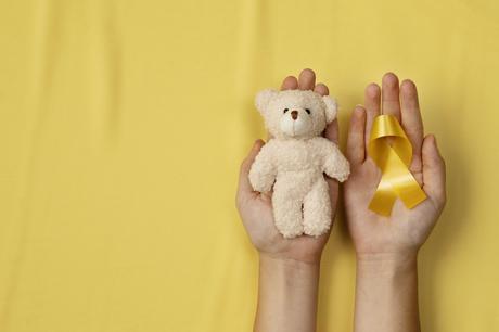 top-view-childhood-cancer-awareness-month-background-concepttoys